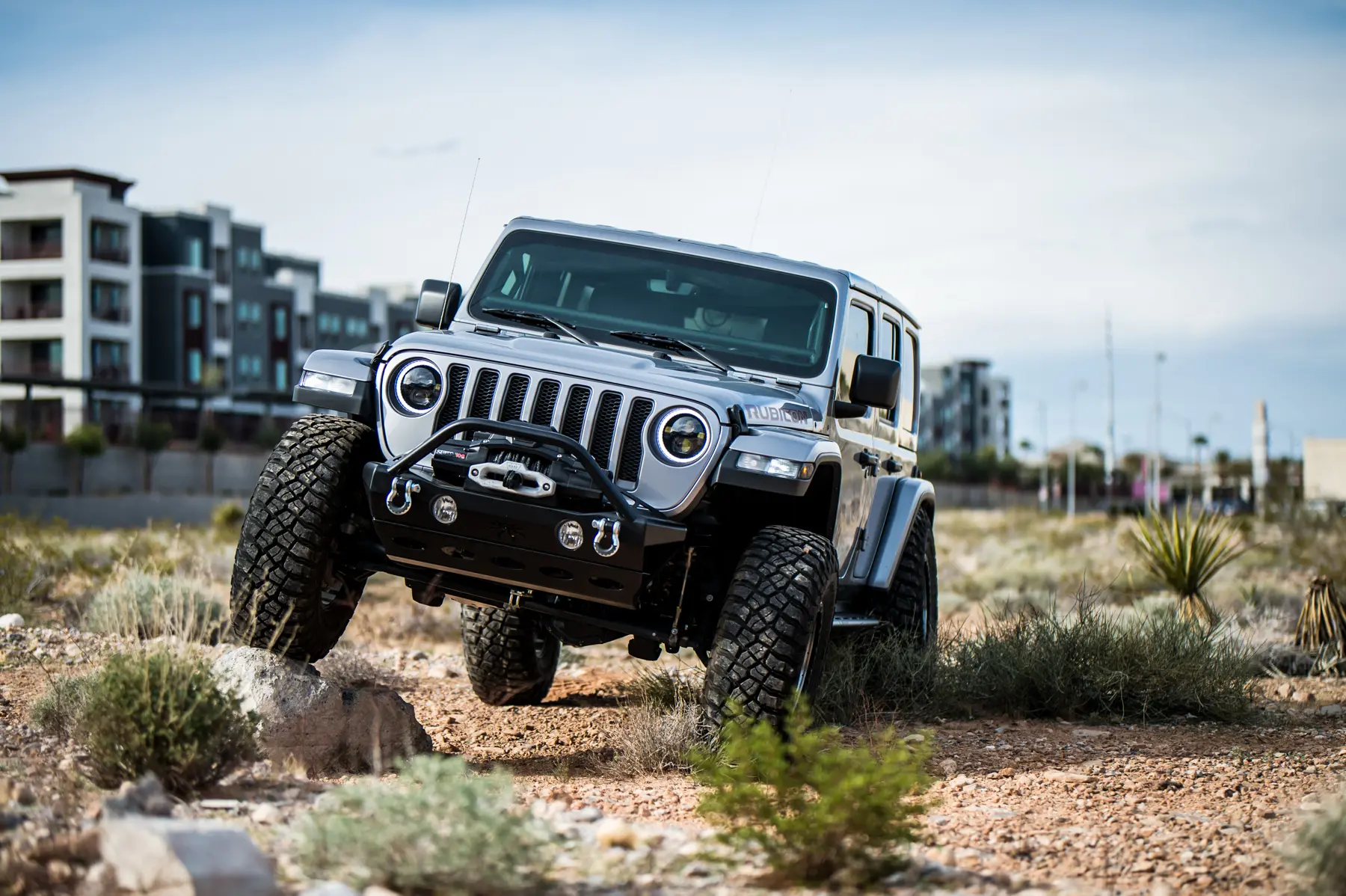 The Jeep Wrangler Rubicon JL shows off its articulation on a rocky outcrop