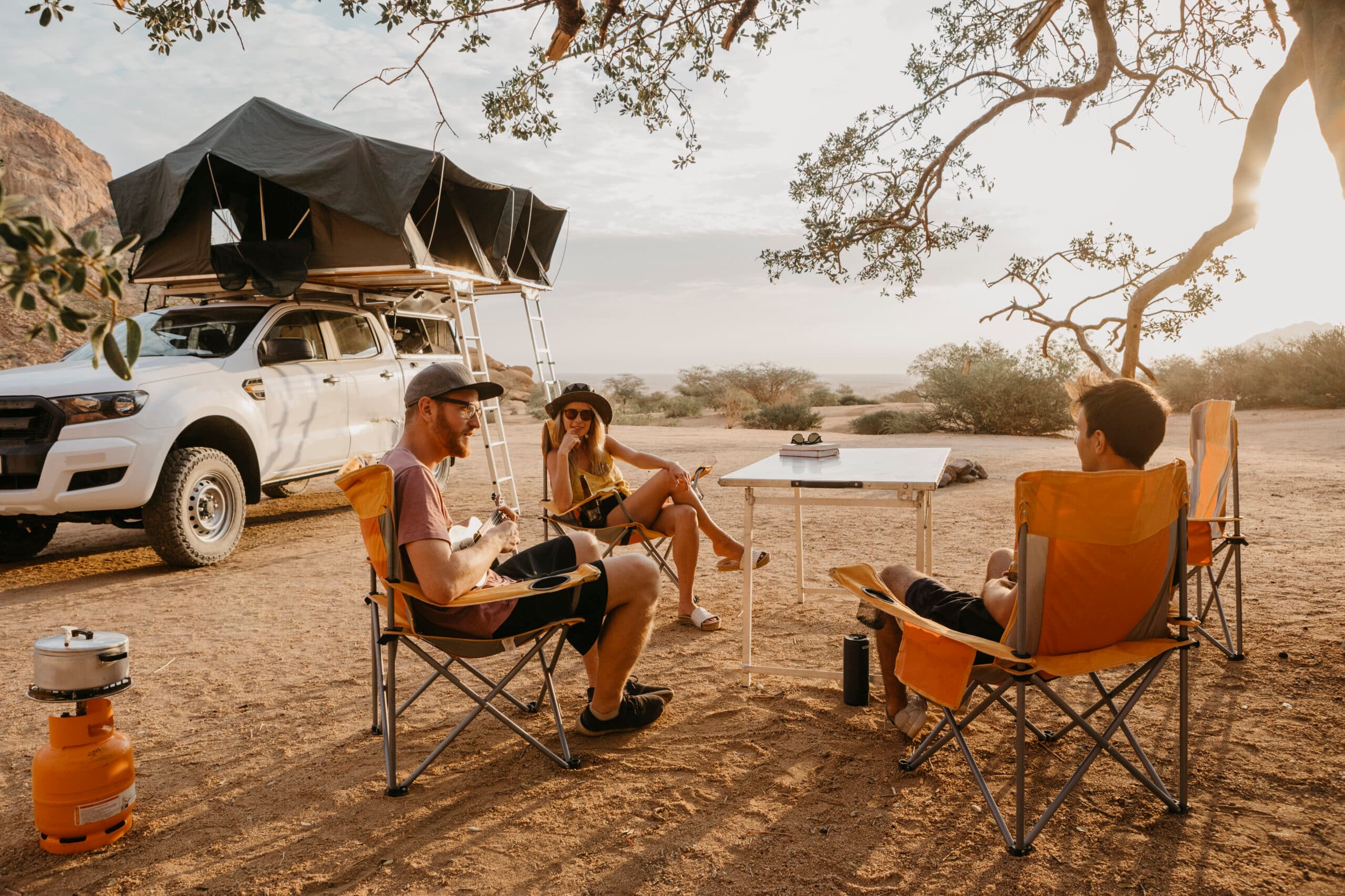 a car with a roof tent, outdoor camping with friends